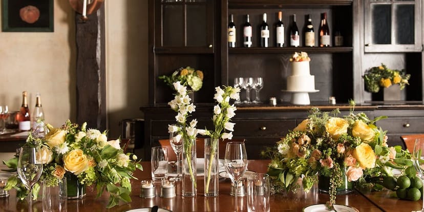 Elegant table setting with floral arrangements at Gramercy Tavern for upscale events.