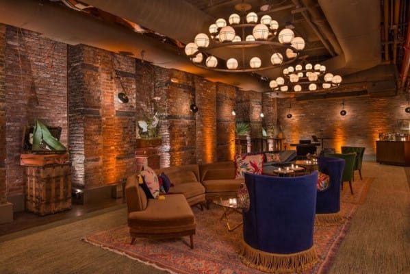 Stylish event space at The Cellar, featuring exposed brick and vibrant decor for gatherings.