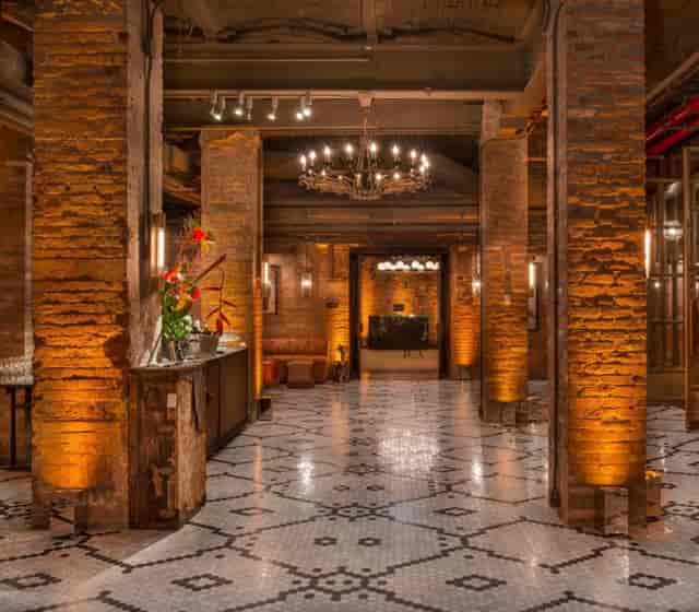 Elegant event space with exposed brick walls, perfect for upscale gatherings and receptions.