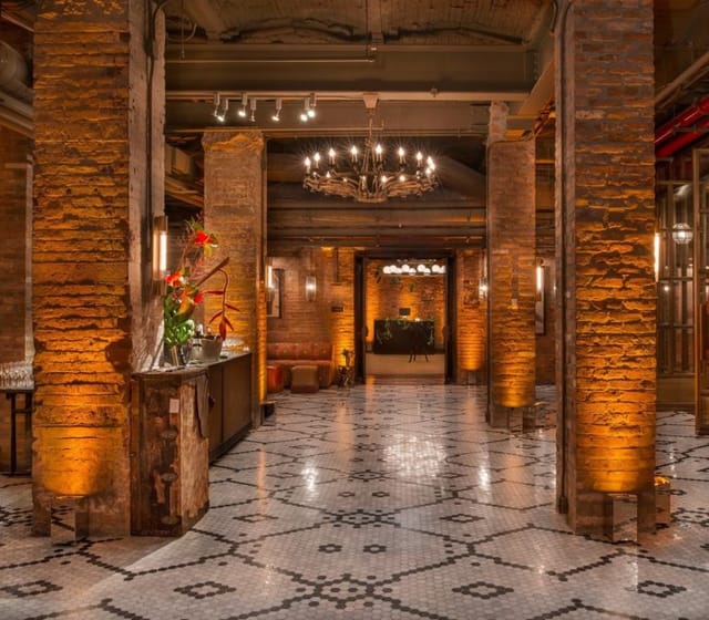 Elegant event space with exposed brick walls, perfect for upscale gatherings and receptions.