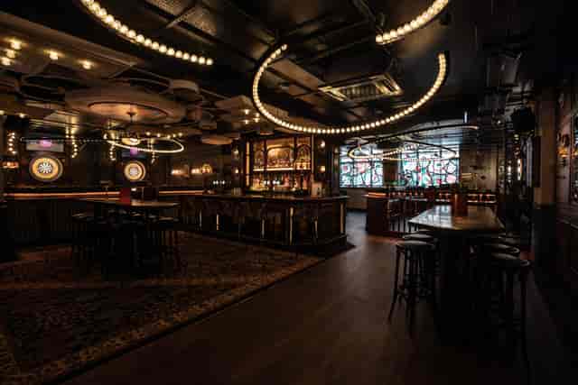 Stylish event space at Flight Club Birmingham with modern bar and ambient lighting.