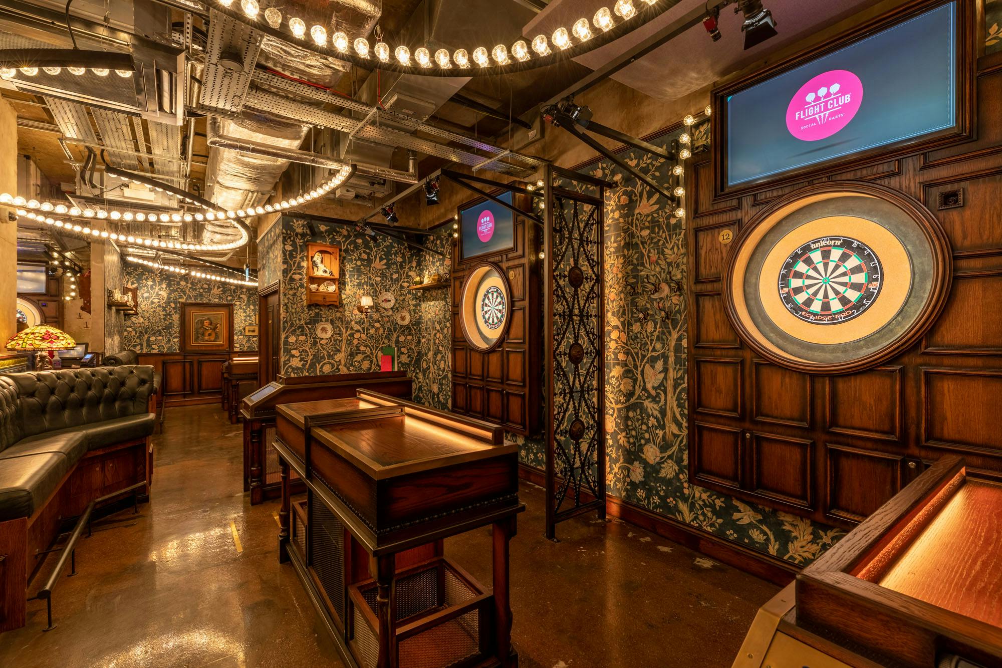 Stylish event space at Flight Club Leeds with dartboards for social gatherings.