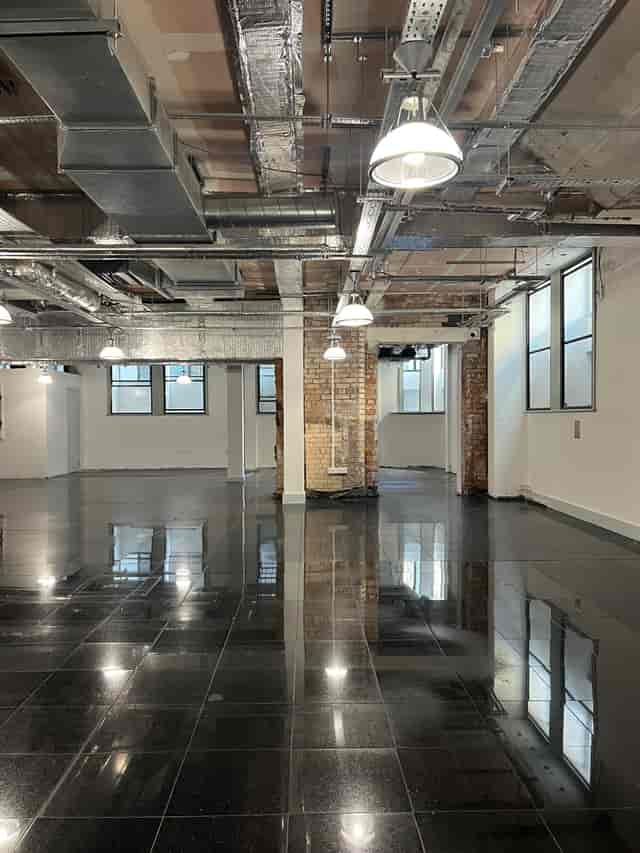Versatile event space with polished floors and industrial design for corporate meetings.
