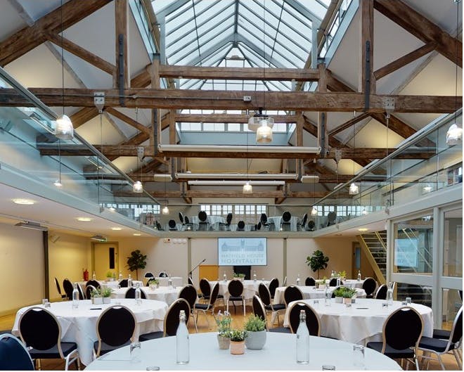 Riding School at Hatfield House: rustic event space with high ceilings for conferences and workshops.