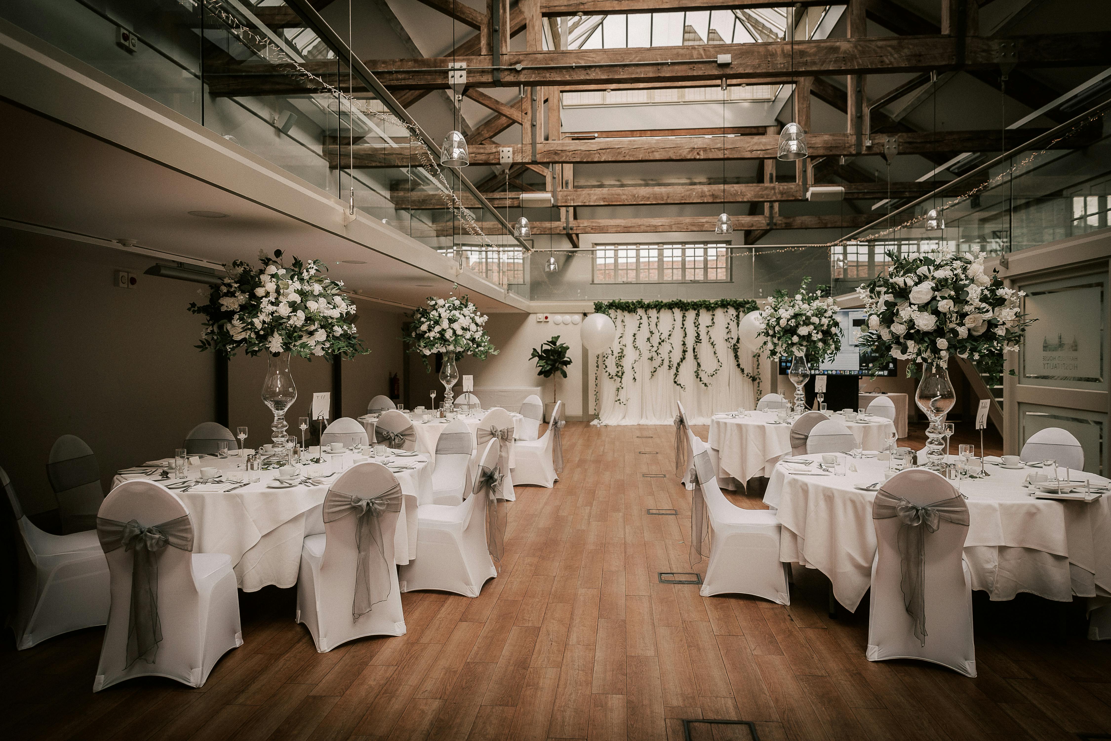 Elegant event space at Hatfield House with floral centerpieces, ideal for weddings.