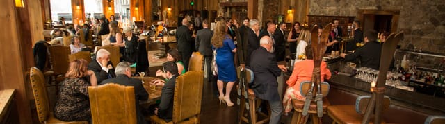 Appalachian Hotel networking event with warm wood decor and engaged attendees.