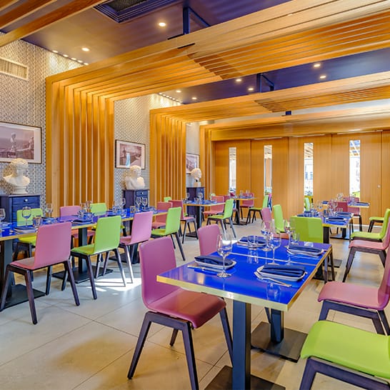 Private dining room with colorful chairs, ideal for events and meetings in Positano Coast.