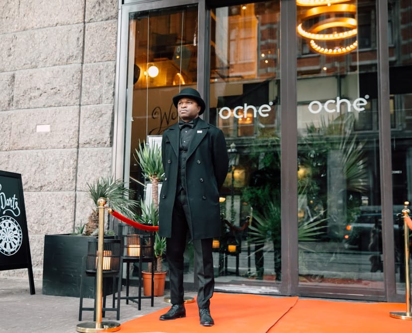 Professional doorman at Oche Venue, Amsterdam; elegant entrance for upscale events.