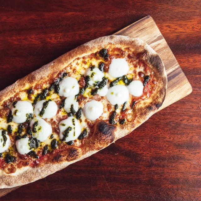 Gourmet flatbread pizza at Oche Venue, ideal for networking events and casual gatherings.