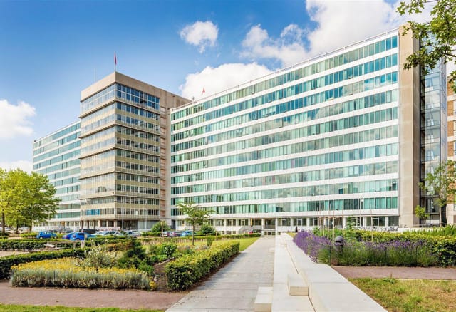 Modern multi-story venue with glass windows, ideal for corporate events and meetings.