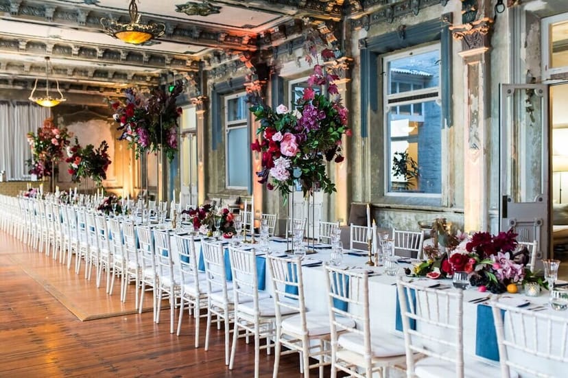 Elegant banquet table with floral centerpieces in upscale event venue for weddings.