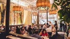 Semi-private restaurant area with warm lighting, ideal for events and gatherings.