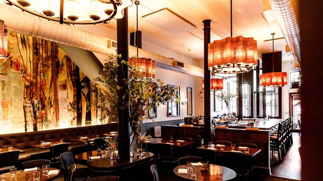 Semi-private restaurant area with warm lighting for intimate gatherings and corporate events.