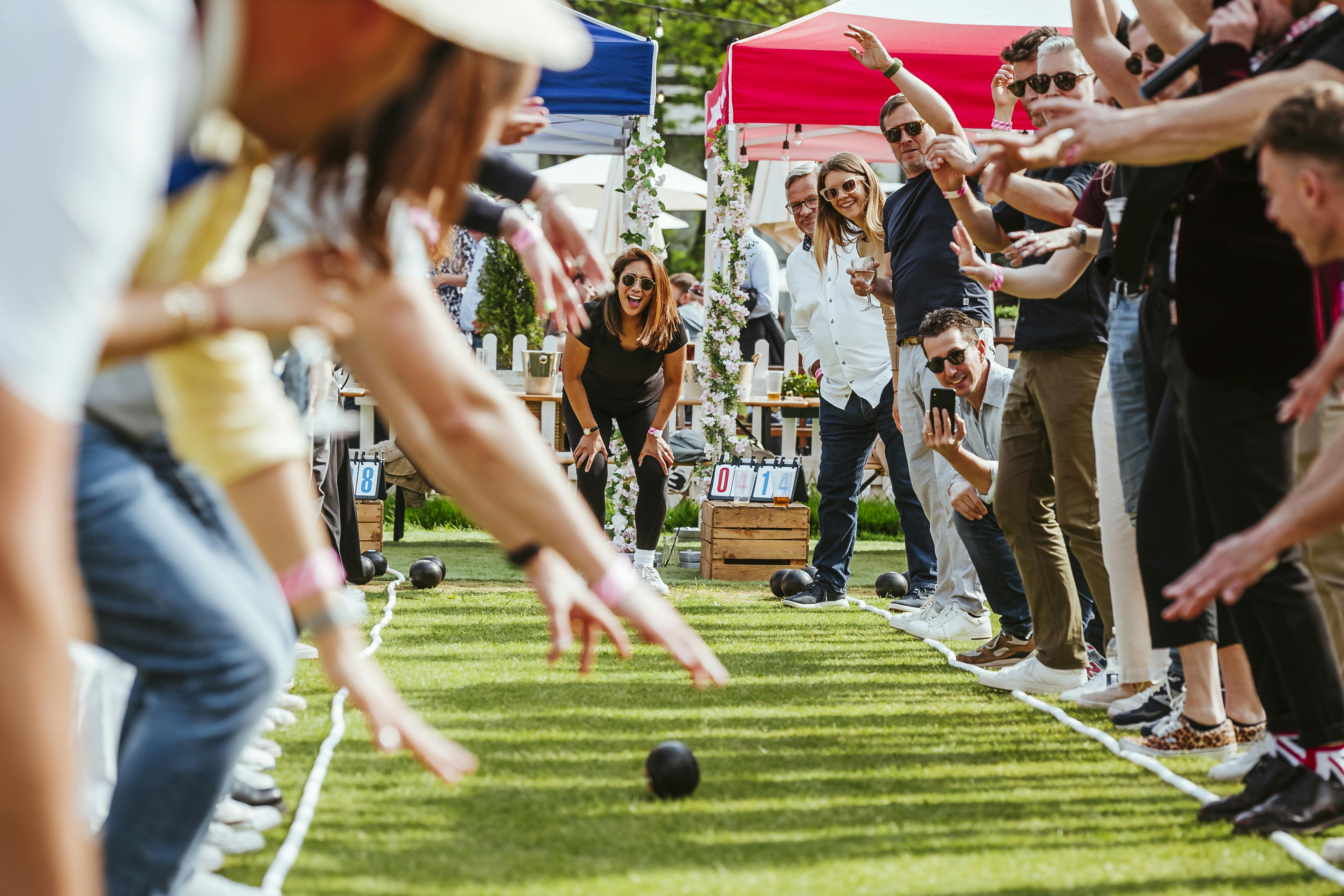 Lively outdoor bocce event at The Bowls Club, Finsbury Square with colorful tents.