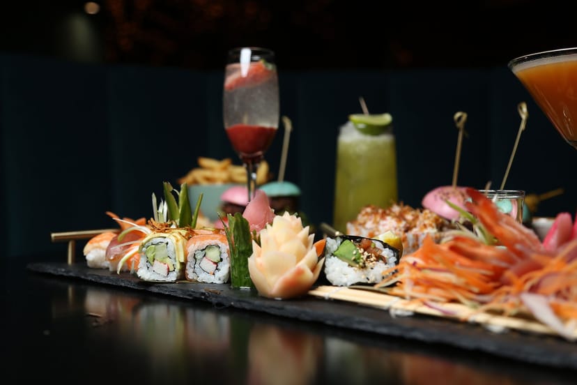 Sushi platter and cocktails at The Clubhouse, perfect for upscale events and gatherings.