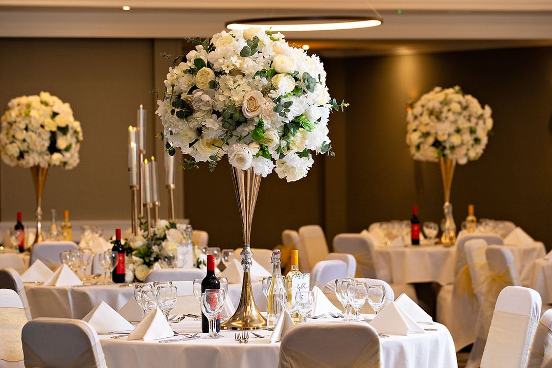 Elegant Ealing Suite with floral centerpieces, ideal for weddings and upscale events.