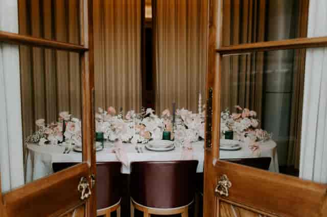 Elegant wedding table setting at St Pancras Brasserie with floral decor and candlelight.