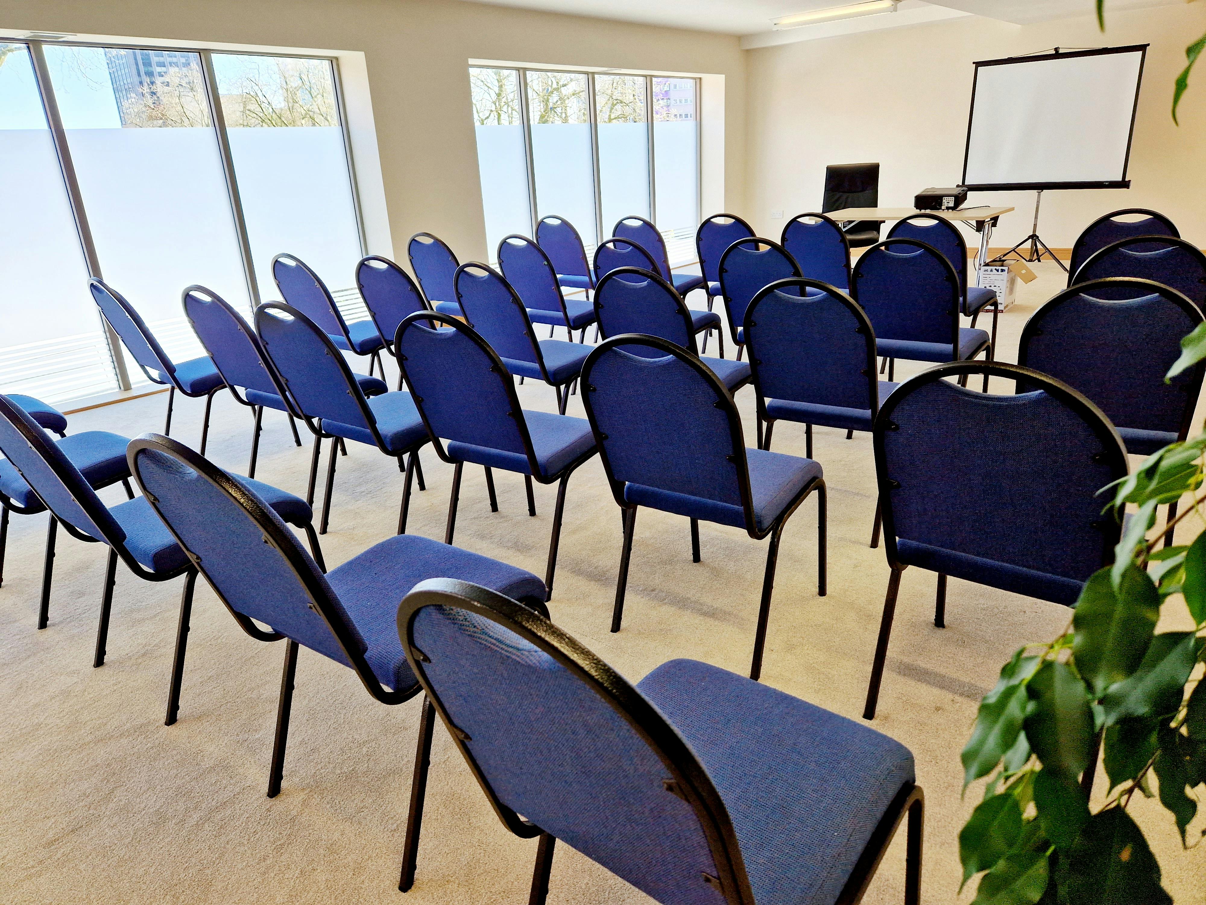 Upper Floor Suite with blue chairs, perfect for corporate meetings and workshops.