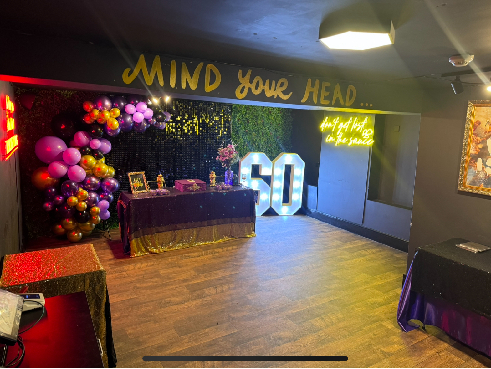 Vibrant birthday celebration with colorful balloons and elegant decor in event space. - Banner