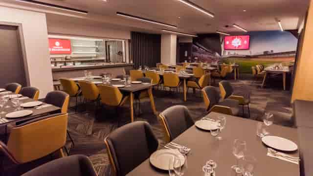 Modern event space at Brentford FC with elegant tables for corporate gatherings.