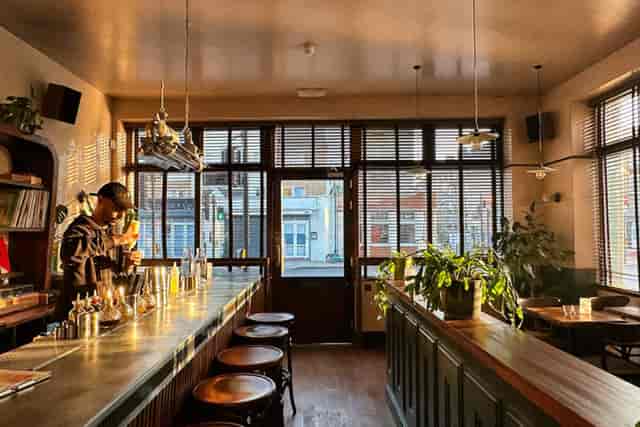 Stylish bar with natural light, perfect for cocktail receptions and networking events.