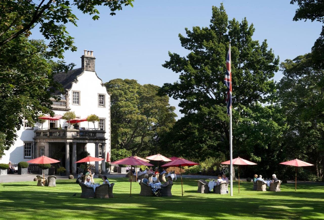 Elegant garden lawns at Prestonfield House with vibrant umbrellas for outdoor events.