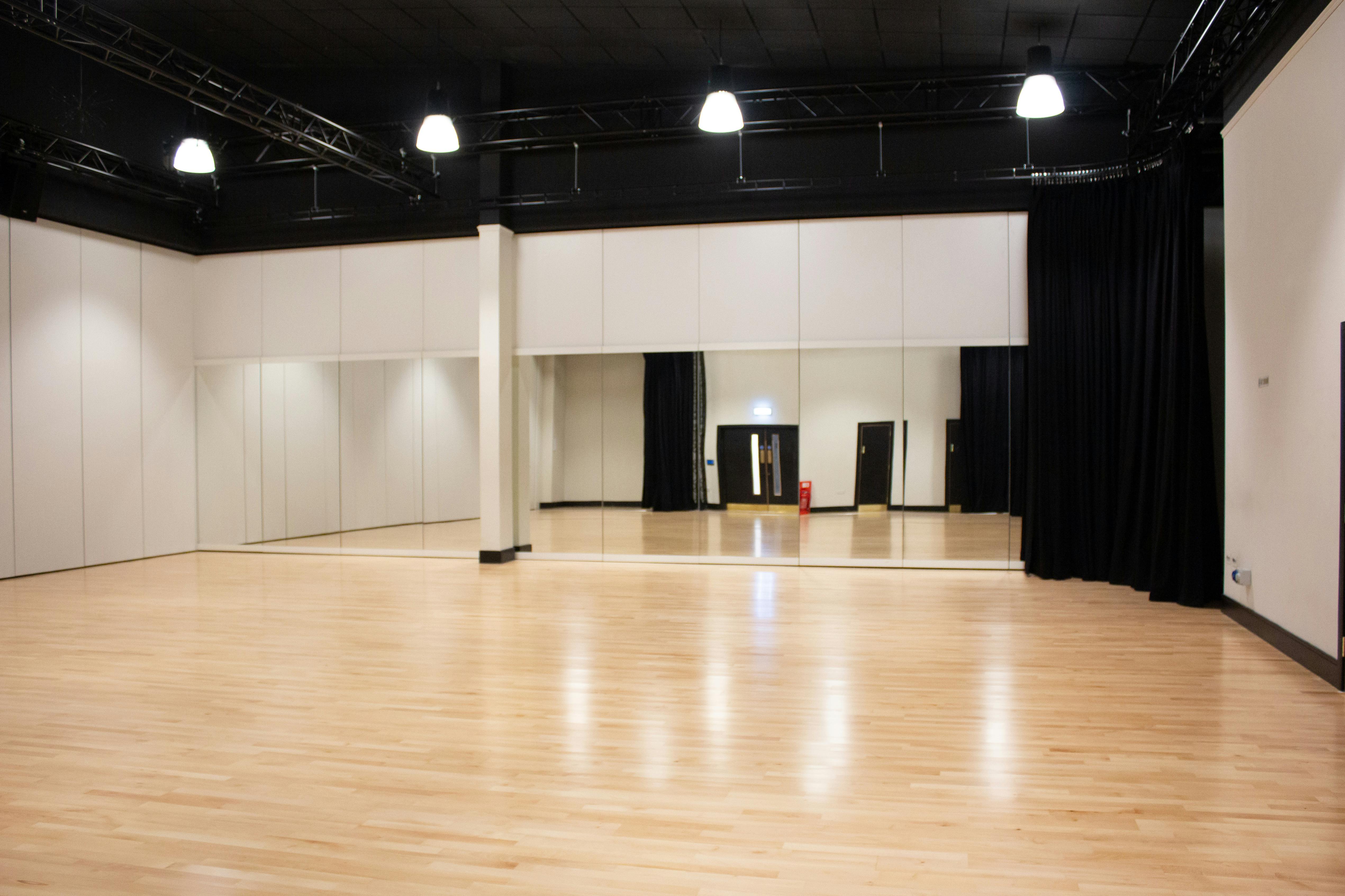 Dance and fitness studio in Anchor Point with polished wooden floors for workshops and classes.