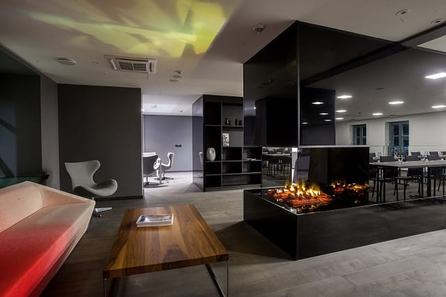 Modern meeting space in Pullman Riga with stylish fireplace, ideal for events and collaboration.