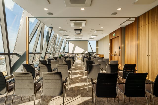 Modern meeting room with floor-to-ceiling windows at AC Hotel Riga for workshops and presentations.