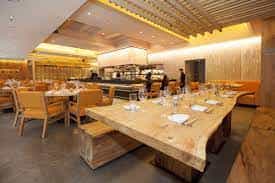 Private dining room at Roka Akor with a large wooden table for corporate events.