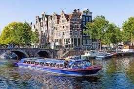 Scenic Amsterdam canal with charming architecture, ideal for unique events and private tours.