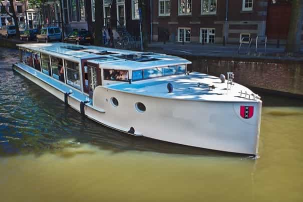 Sleek event boat Monne de Miranda for corporate gatherings on scenic canals.