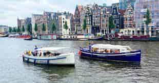 Private boats in scenic canal for waterfront events and team-building activities.