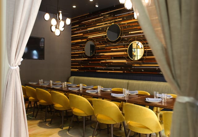 Stylish private dining room with modern decor for upscale events and meetings.