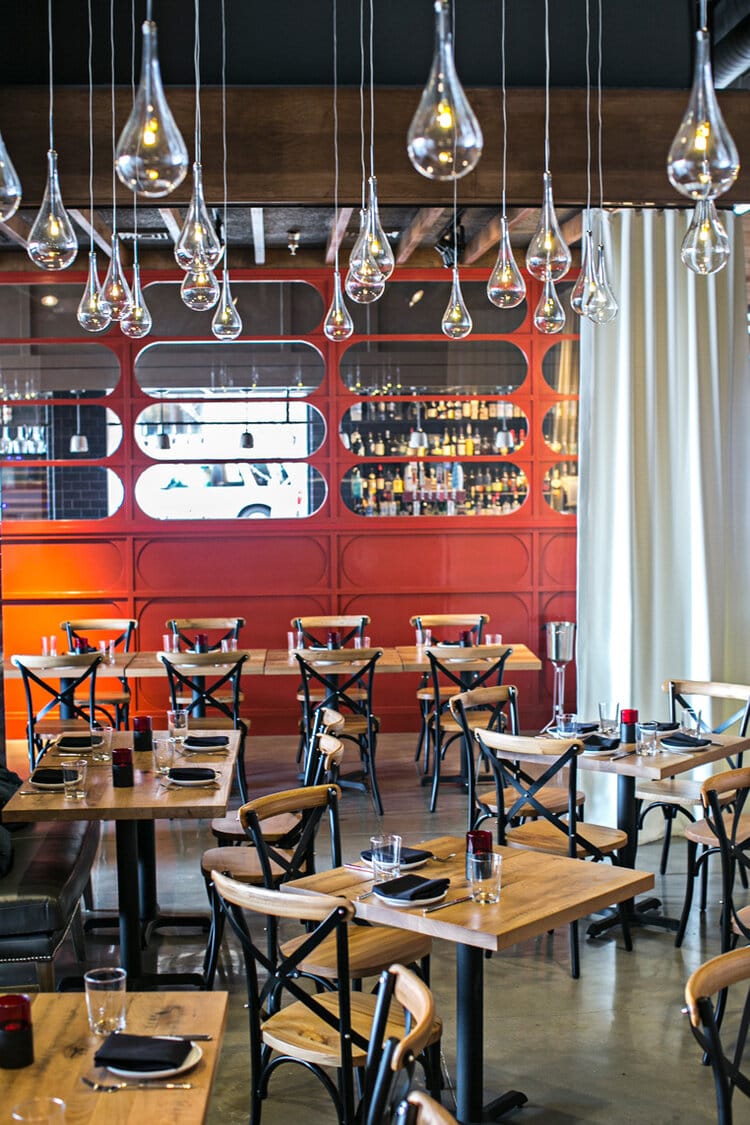 Stylish Bayonne Room with red accent wall, perfect for intimate gatherings and corporate events.