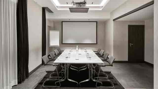 Modern meeting room at Hyatt Centric Milan with sleek table, ideal for conferences and events.