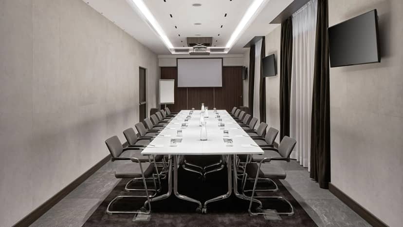 Modern conference room at Hyatt Centric Milan with ergonomic chairs for meetings.