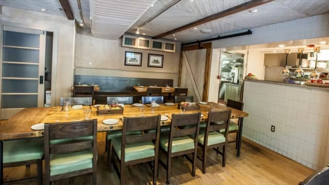Intimate dining space with wooden table for team-building events in Agricola.