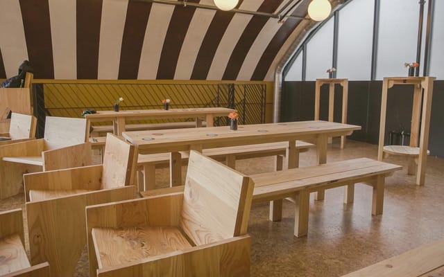 Modern event space with wooden furniture for workshops at Locks Industrial Brewery.