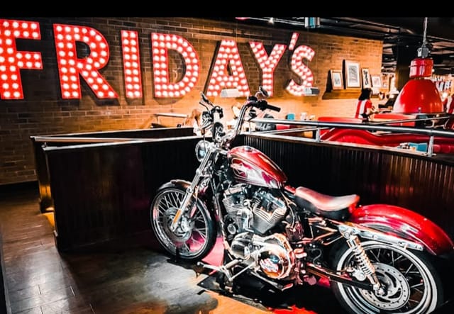 Vibrant restaurant venue with motorcycle display for casual gatherings and themed events.