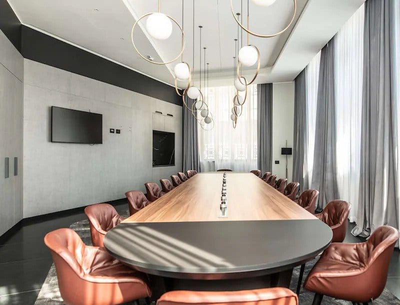 Modern conference room with sleek table and leather chairs for corporate meetings in Milan.