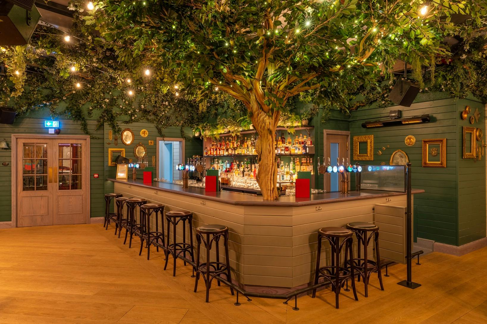 Vibrant bar with lush greenery, ideal for events and social gatherings in Cardiff.