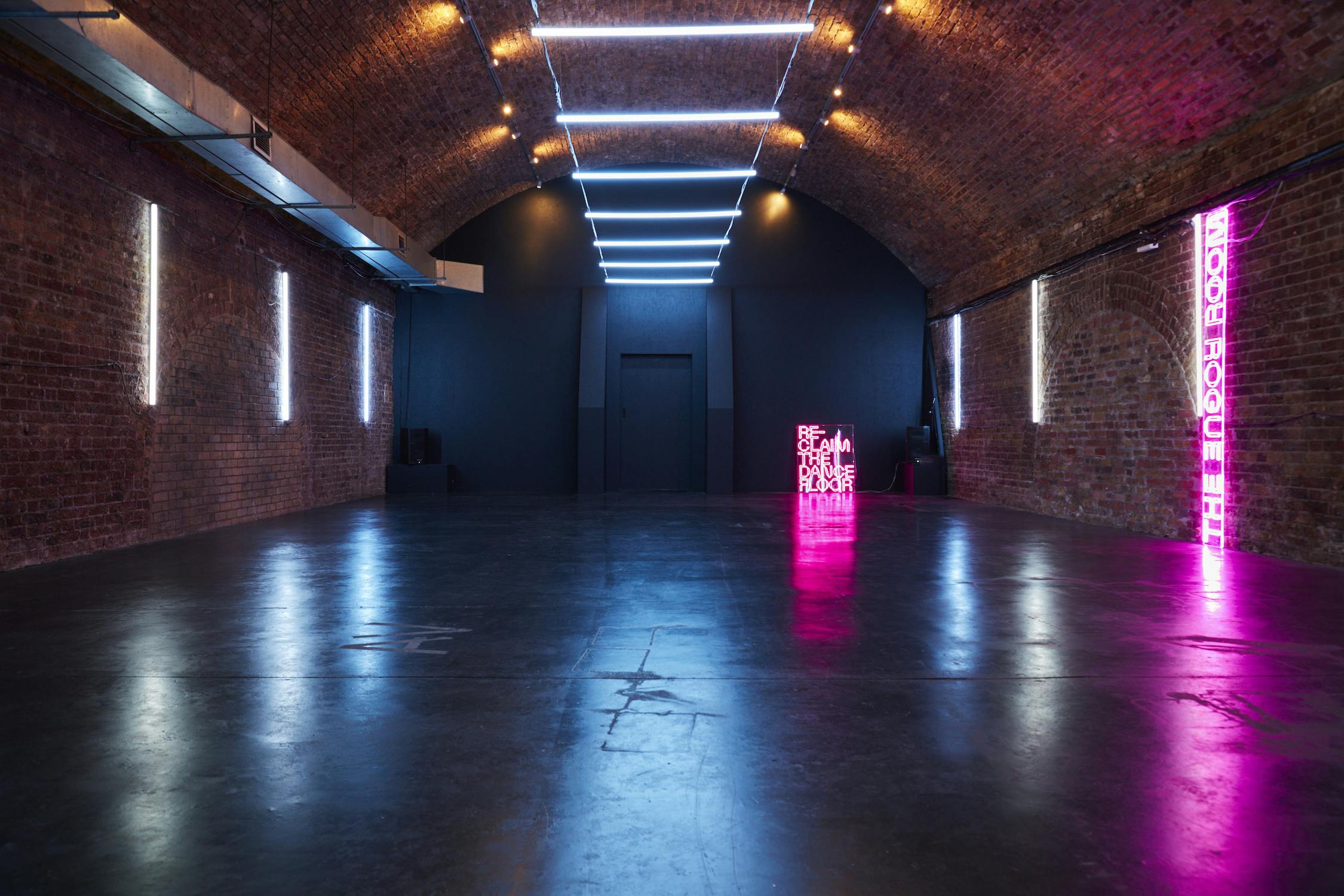 Versatile event space with exposed brick walls, ideal for conferences and workshops.