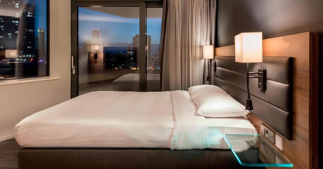 Modern hotel room at Moxy London Stratford, ideal for events and meetings.