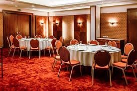 Almaty meeting room with round tables, ideal for events and networking.