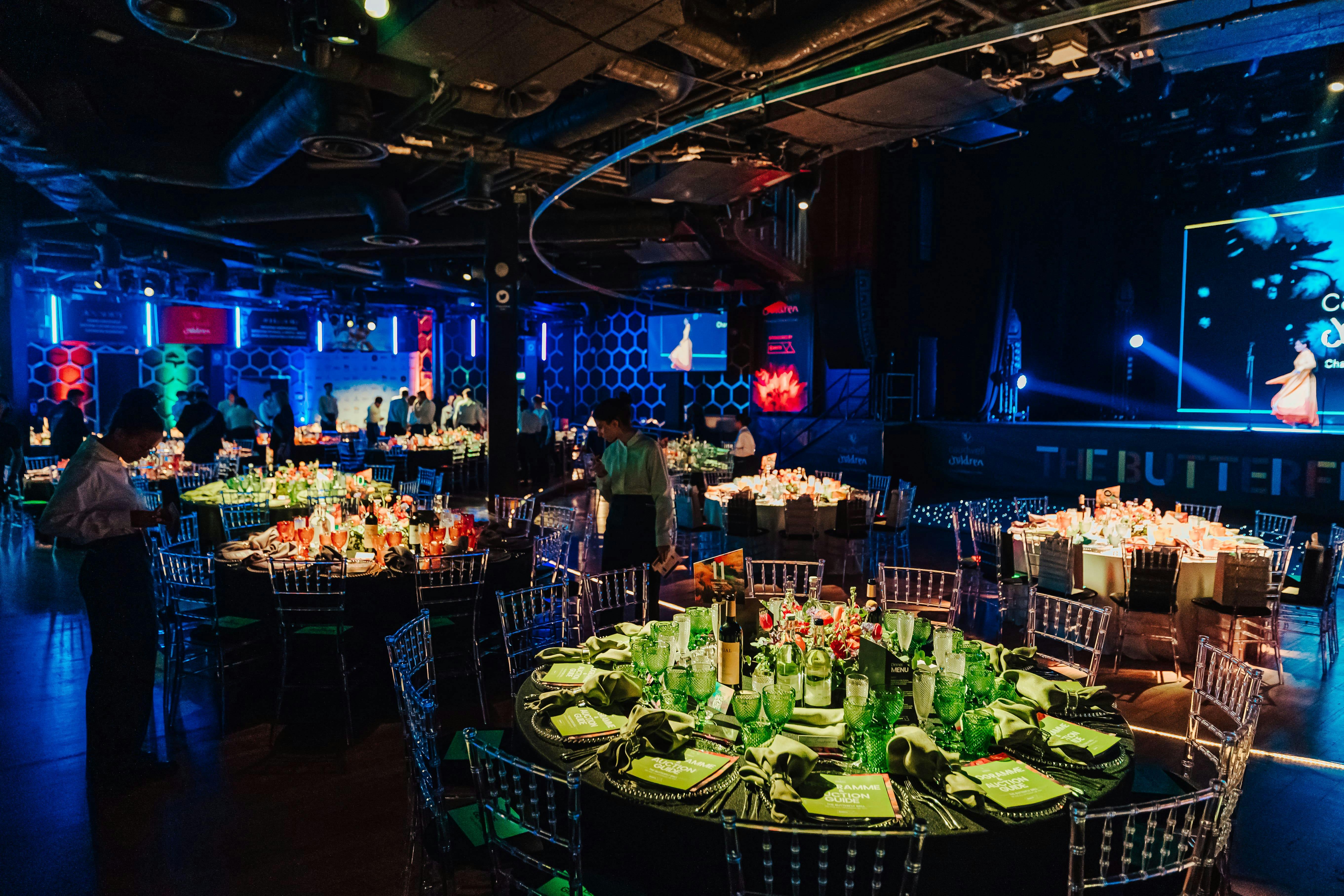 Vibrant formal dinner setup at The O2, featuring elegant tables and ambient lighting.