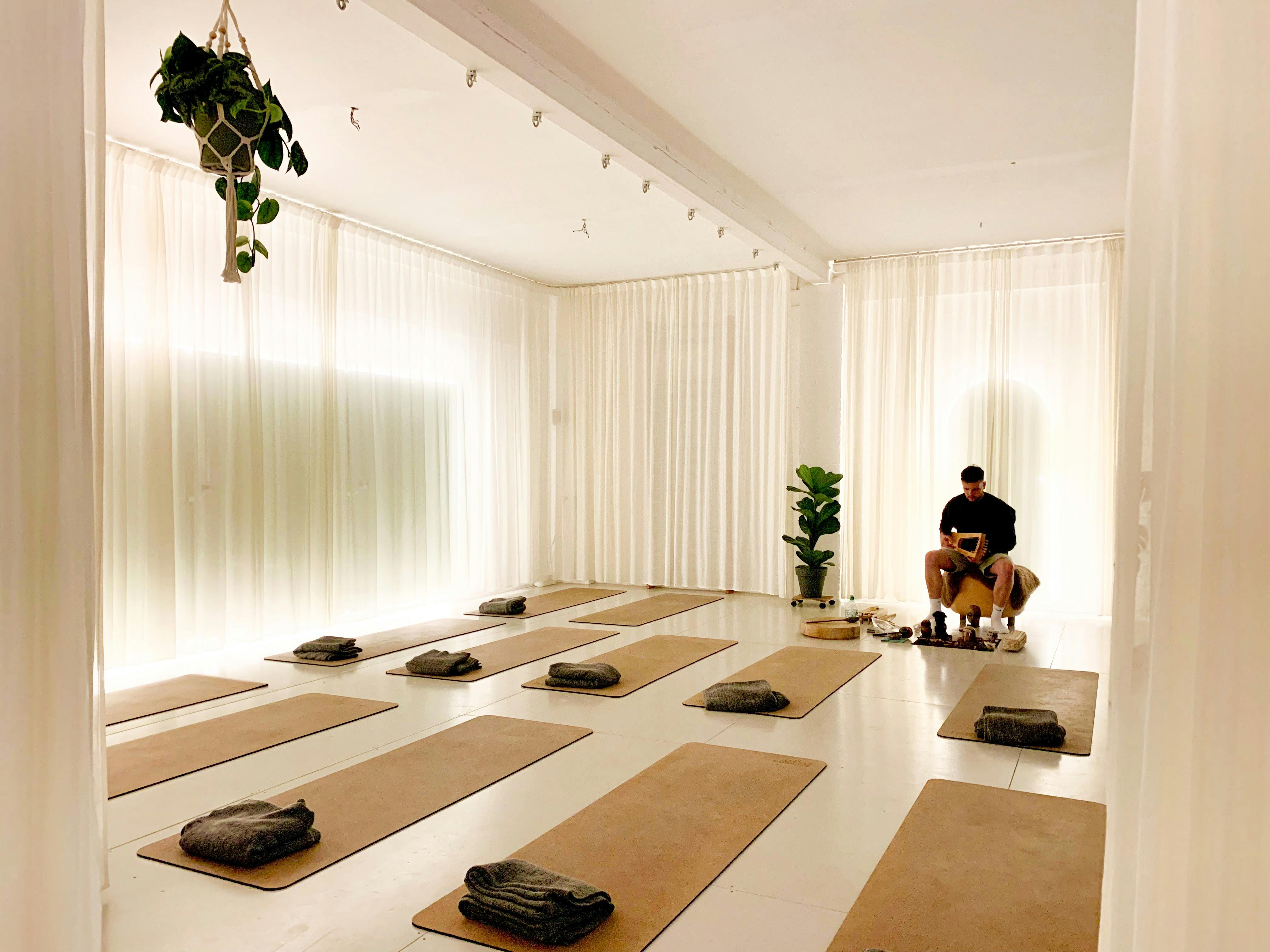 Serene yoga studio with mats, ideal for wellness retreats and mindfulness workshops.