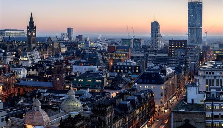 Treehouse Hotel Manchester skyline at dusk, ideal for conferences and networking events.