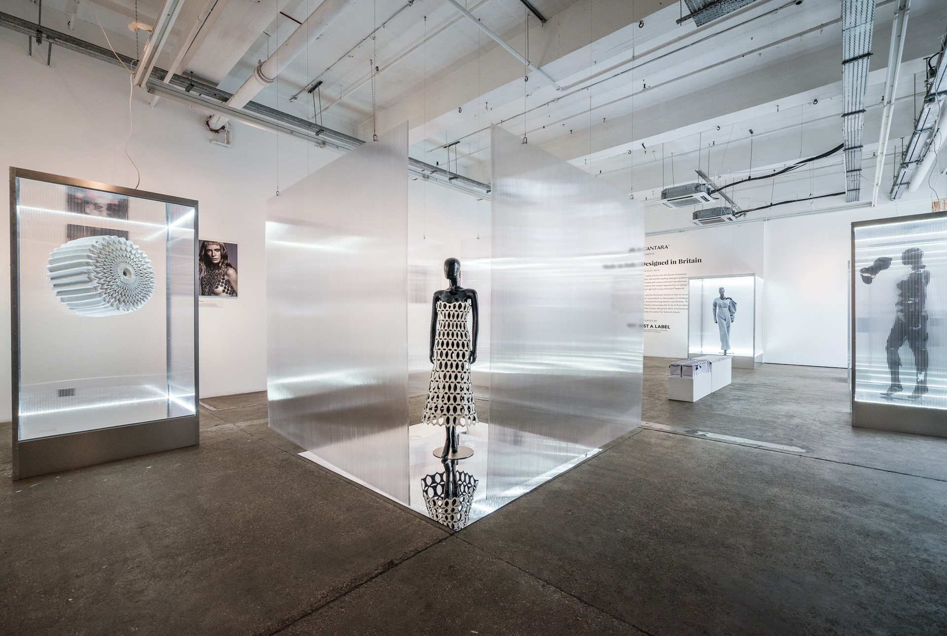 Modern exhibition space with illuminated displays for art showcases and product launches. - Banner