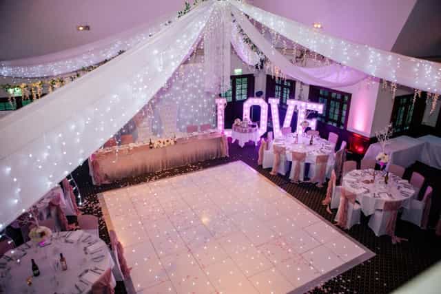 Taylor Suite at Woolston Manor, elegant wedding venue with fairy lights and "LOVE" display.
